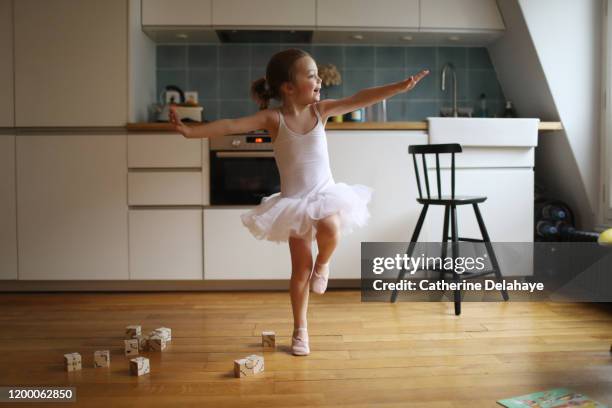 a 4 years old girl dressed as a dancer, dancing in the kitchen - 4 5 years stock-fotos und bilder