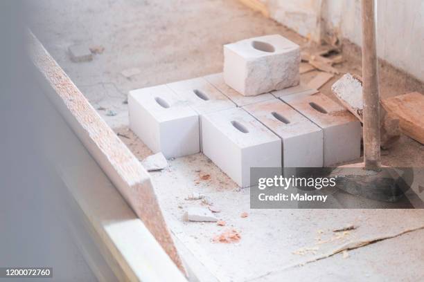 close-up of bricks and hammer on the ground. - rebuilding stock pictures, royalty-free photos & images