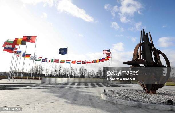 Flags of members of North Atlantic Treaty Organization wave behind the NATO's star sculpture outside of the NATO Headquarters in Brussels, Belgium on...
