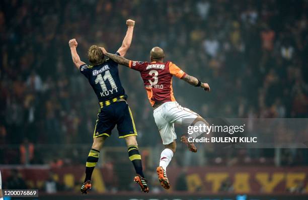 Fenerbahce's Dirk Kuyt vies in the air with Galatasaray's Felipe Melo during the Turkish Super League football match between Fenerbahce and...