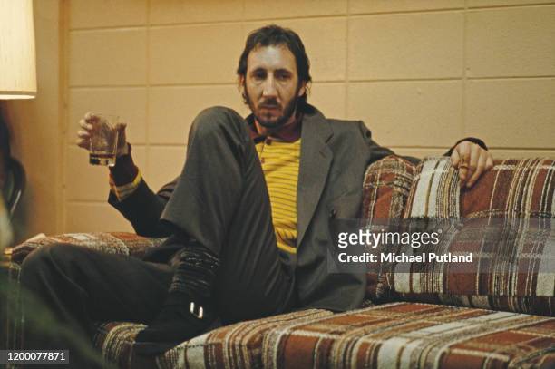 English guitarist Pete Townshend of The Who relaxes with a drink backstage during the band's tour of the United States in September 1979.