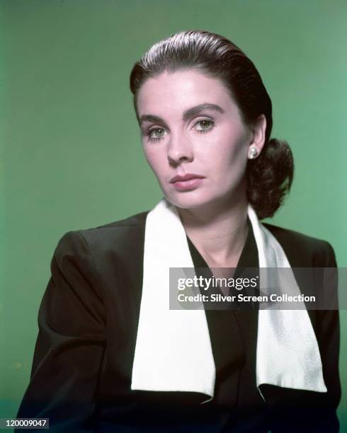 Jean Simmons . Britiish actress, wearing a black jacket with white lapels in a studio portrait, against a green background, circa 1950.