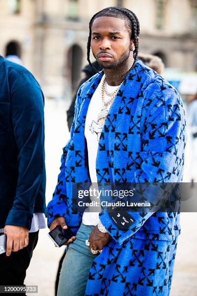 Rapper Pop Smoke, wearing a blue Off-White coat, is seen outside