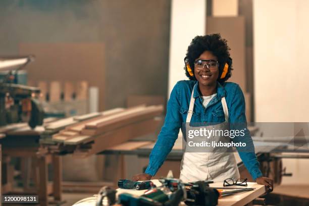 portrait of a young female carpenter - carpenter stock pictures, royalty-free photos & images