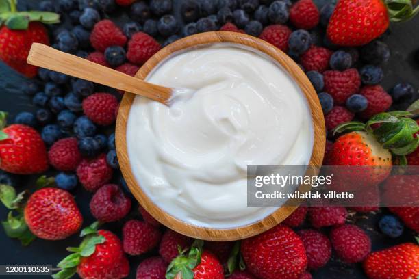 greek yogurt in a glass jars with spoons,healthy breakfast with fresh greek yogurt, muesli and berries on background - yogurt stock pictures, royalty-free photos & images