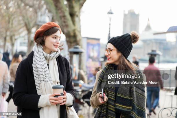 female friends walking at embankment river thames. - city breaks winter stock pictures, royalty-free photos & images