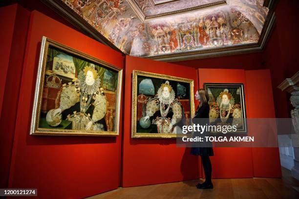 Curator, Allison Goudie poses with the three surviving versions of the iconic Armada Portrait of Elizabeth I during a photocall ahead of the opening...