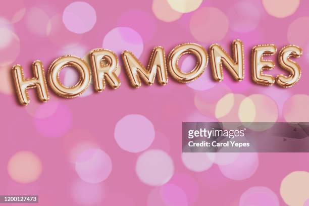 hormones  in foiled balloon - hormone stock-fotos und bilder