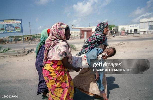 Women cry as they carry one of the 14 civilians killed by Pakistani United Nations peacekeeping troops 13 June 1993 in Somalia. The troops opened...