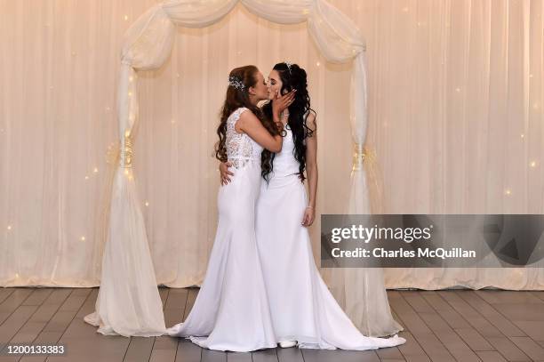 Robyn Peoples and Sharni Edwards kiss each other after they became Northern Ireland's first legally married same sex couple on February 11, 2020 in...