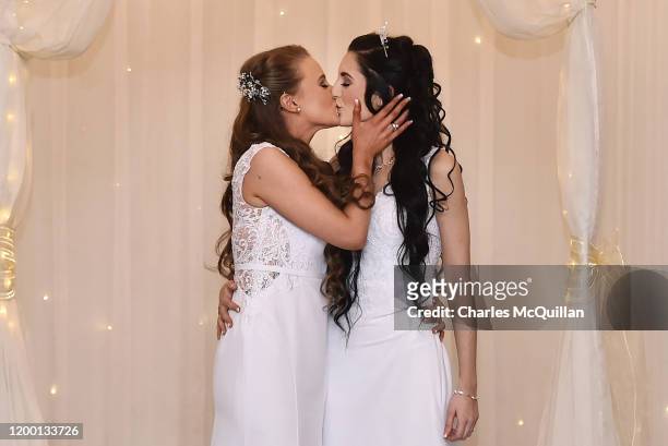 Robyn Peoples and Sharni Edwards embrace and kiss after they became Northern Ireland's first legally married same sex couple on February 11, 2020 in...