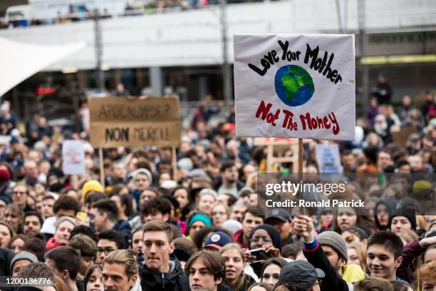 Protestor holds a sign at a demonstration against climate change where climate activist Greta Thunberg addressed a multitudinary crowd on January 17,...