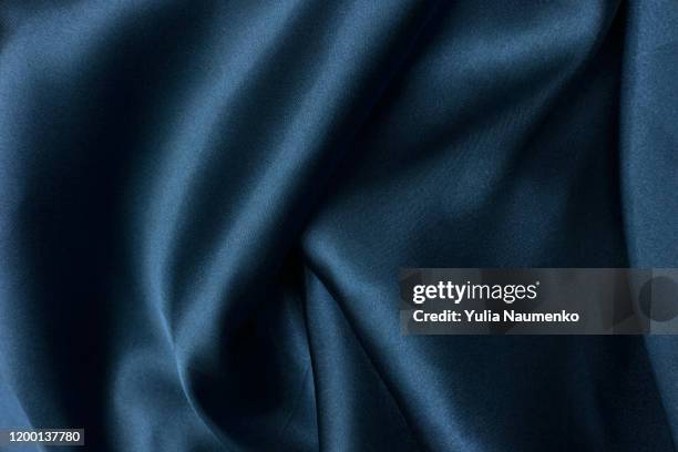 wavy folds of grunge blue silk texture satin velvet material or luxurious blue silk as background, folds of blue silky fabric. - abstract pattern smooth stock pictures, royalty-free photos & images