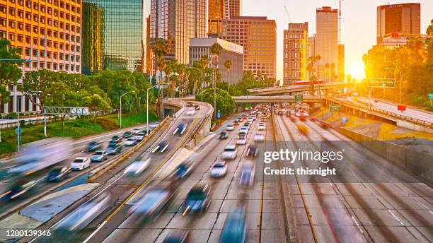 sunset. highway. los angeles financial district - busy highway stock pictures, royalty-free photos & images