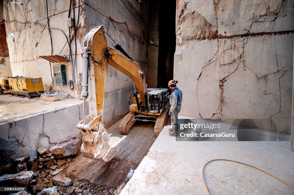 Earth Mover Removing Rocks and Making Way in Marble Quarry