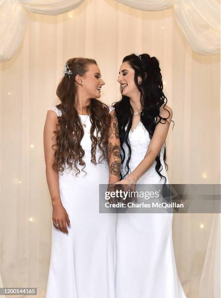 Robyn Peoples and Sharni Edwards embrace and kiss after they became Northern Irelands first legally married same sex couple on February 11, 2020 in...