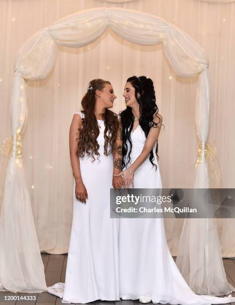Robyn Peoples and Sharni Edwards embrace and kiss after they became Northern Irelands first legally married same sex couple on February 11, 2020 in...