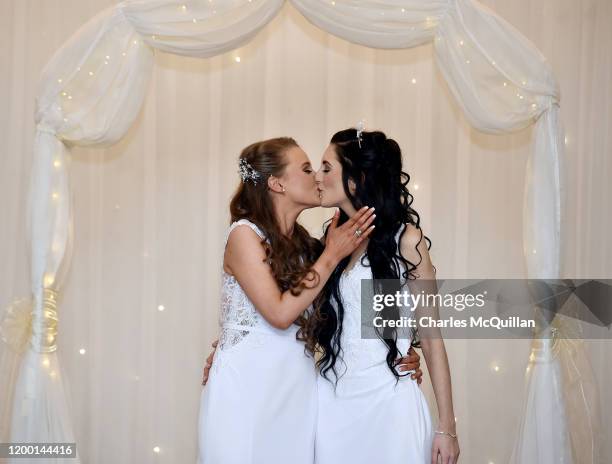 Robyn Peoples and Sharni Edwards embrace and kiss after they became Northern Irelands first legally married same sex couple on February 11, 2020 in...