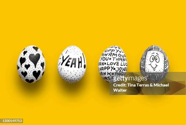painted easter eggs on yellow background. flat lay. - easter stock-fotos und bilder