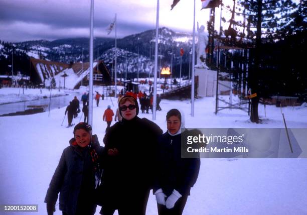 American comedienne, actress, singer and businesswoman Edie Adams poses with step-daughters Kippie and Elizabeth Kovacs under the Olympic Cauldron...