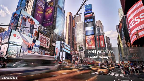 motion at times square. traffic. yellow taxi. day. - digital signage night stock pictures, royalty-free photos & images