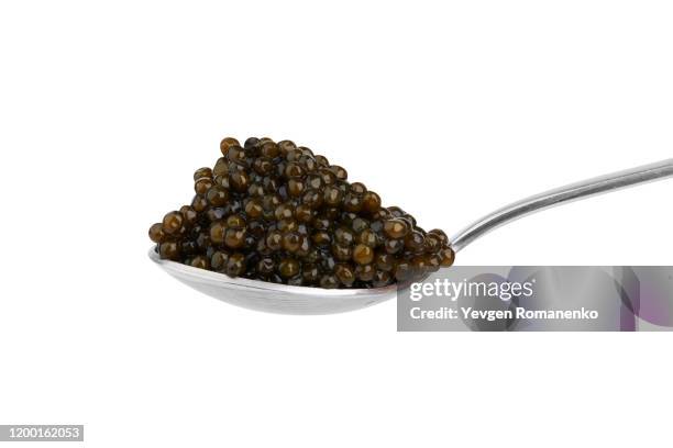 black sturgeon caviar in silver spoon, isolated on white background - caviar stock pictures, royalty-free photos & images