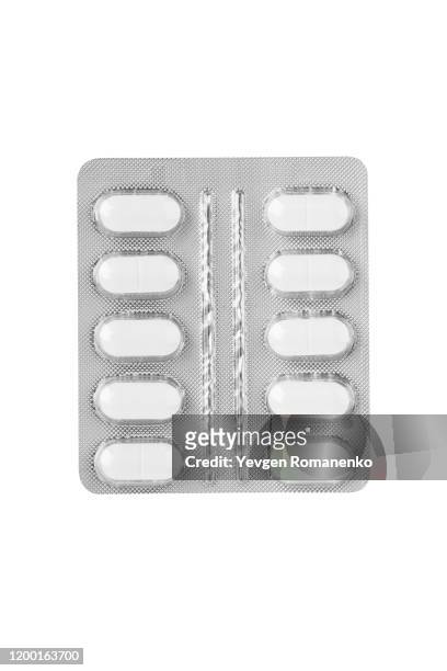 white pills in a blister pack on white background - blister fotografías e imágenes de stock