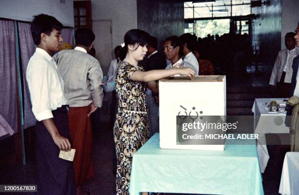 Voters cast their ballot at a polling place, on May 27, 1990 in Rangoon during Burma's first multiparty election in 30 years. The elections were won...