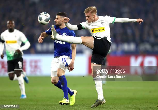 Oscar Wendt of Borussia Monchengladbach and Daniel Caligiuri of FC Schalke 04 during the Bundesliga match between FC Schalke 04 and Borussia...