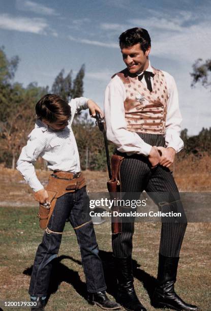 Actor Hugh O'Brian as Wyatt Earp with Brad Morrow carrying guns in the TV series "The Life and Legend of Wyatt Earp" in Los Angeles, California.