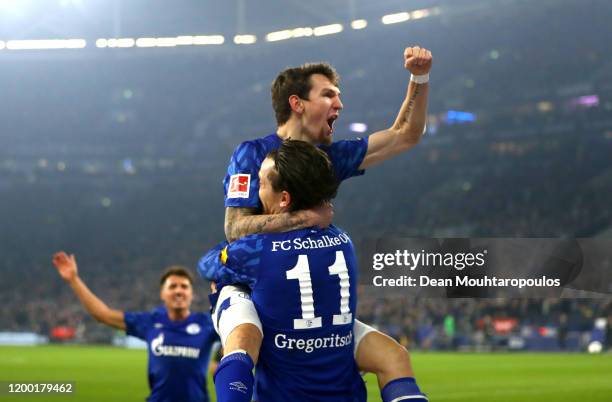 Yevhen Konoplyanka of FC Schalke 04 celebrates scoring his sides first goal with Benito Raman of FC Schalke 04 during the Bundesliga match between FC...