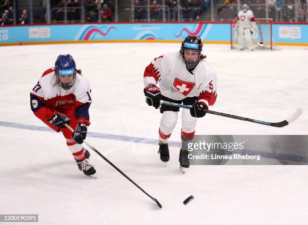 Aneta Dyckova of Czech Republic battles for the puck with Elena Gaberell of Switzerland during the Women's Ice Hockey 6-Team Tournament Preliminary...