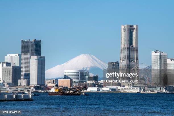 Mount Fuji is seen behind the Yokohama skyline on February 11, 2020 in Yokohama, Japan.