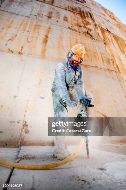 portrait of adult man working with jackhammer in marble quarry - stock photo - jackhammer stock pictures, royalty-free photos & images