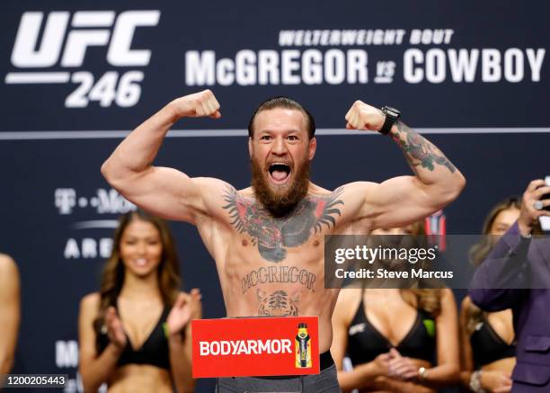 Welterweight fighter Conor McGregor poses on the scale during a ceremonial weigh-in for UFC 246 at Park Theater at Park MGM on January 17, 2020 in...