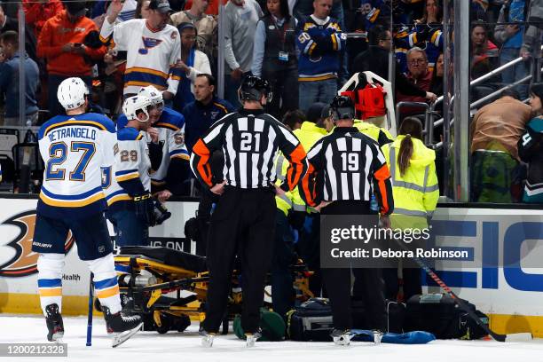 The St. Louis Blues watch as the paramedics tend to Jay Bouwmeester of the St. Louis Blues after he collapsed on the bench during the first period of...