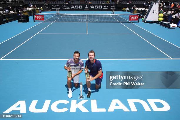 Ben McLachlan of Japan and Luke Bambridge of Great Britain pose with the trophy following their doubles finals match against Marcus Daniell of New...