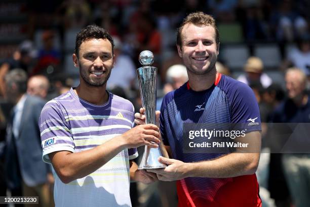 Ben McLachlan of Japan and Luke Bambridge of Great Britain pose with the trophy following their doubles final match against Marcus Daniell of New...