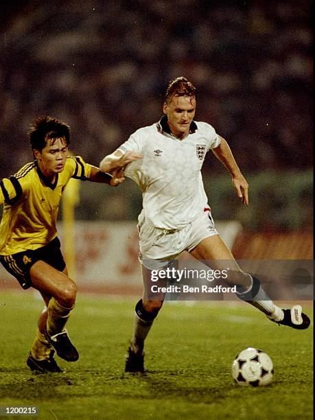 Geoff Thomas of England takes on Chow Siew Yai of Malaysia during a Friendly match at the Shah Alam Stadium in Kuala Lumpur, Malaysia. England won...