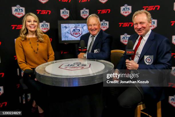 Reporter Sara Orlesky shares a laugh with Randy Carlyle and Thomas Steen during a first intermission interview on Hall of Fame Night between the Jets...