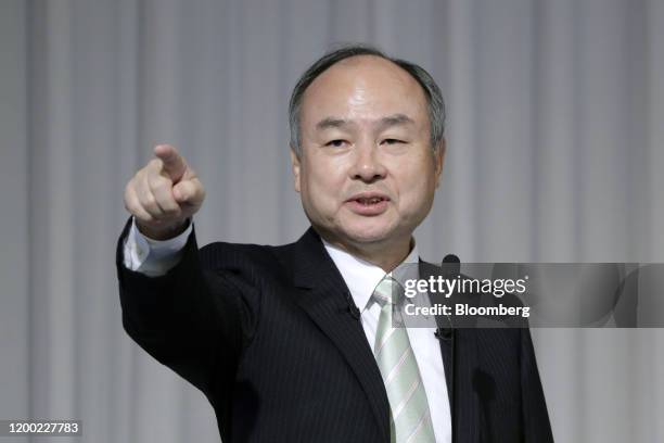 Masayoshi Son, chairman and chief executive officer of SoftBank Group Corp., points at a member of the media during a news conference in Tokyo,...