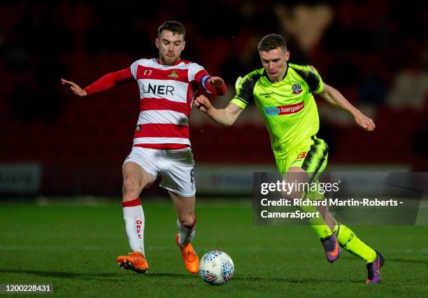 Bolton Wanderers' Ethan Hamilton battles with Doncaster Rovers' Ben Whiteman during the Sky Bet Championship match between Brentford and Leeds United...