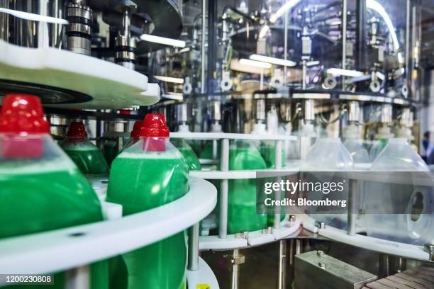 Bottles of Persil Power Gel laundry detergent pass along packaging production line inside the Henkel AG factory in Duesseldorf, Germany, on Thursday,...