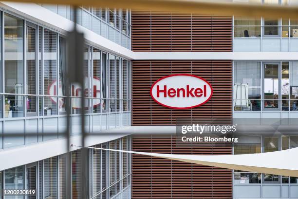 Henkel AG logo sits on display beside office windows at the company's headquarters in Duesseldorf, Germany, on Thursday, Feb. 6, 2020. Henkel report...