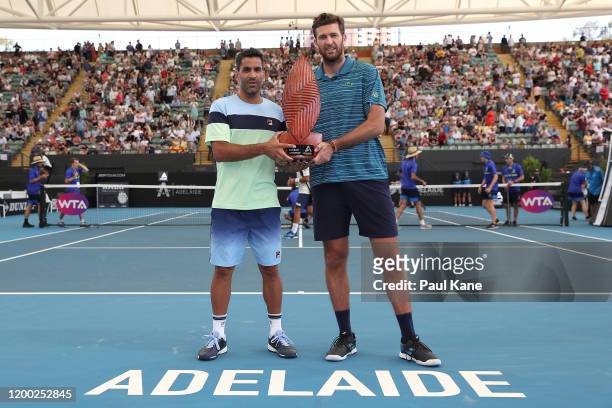 Maximo Gonzalez of Argentina and Fabrice Martin of France pose with the trophy after winning the men's doubles grand final against Ivan Dodig of...