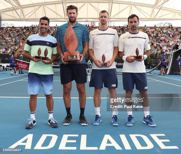 Maximo Gonzalez of Argentina and Fabrice Martin of France pose with Ivan Dodig of Croatia and Filip Polasek of Slovakia following the men's doubles...