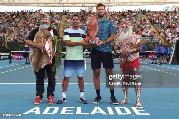 Maximo Gonzalez of Argentina and Fabrice Martin of France pose with the trophy together with Aboriginal elders Mickey Kumatpi O'Brien and Major...