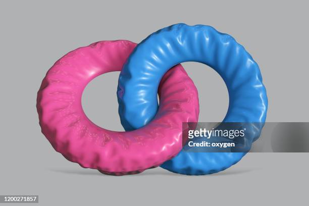 two colorful swim rings on gray background - rubber ring - fotografias e filmes do acervo