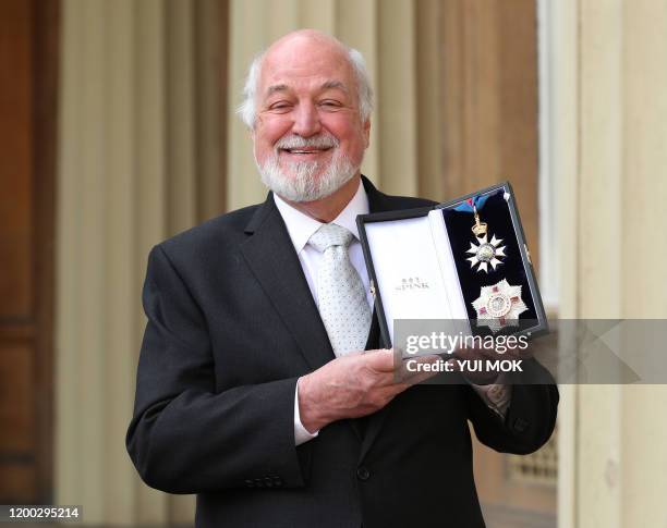 Former chair of the Disasters Emergency Committee Sir Clive Jones poses with his medal after being appointed a Knight Commander of the Order of St...