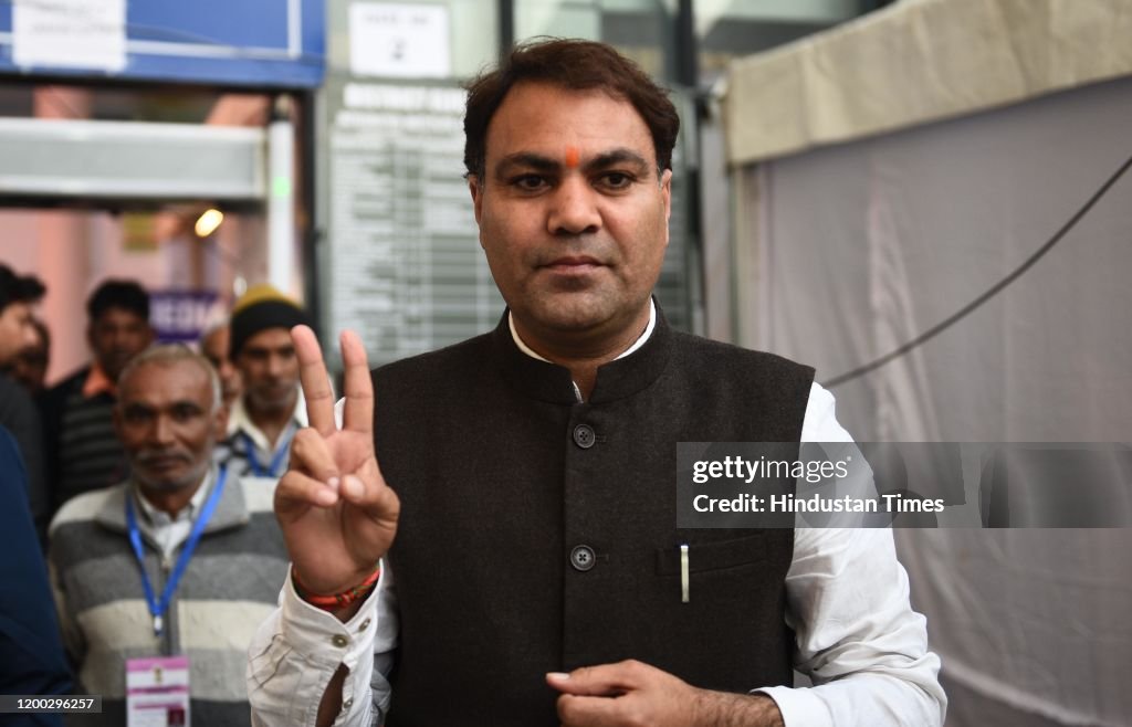 AAP candidate from Matiala Gulab Singh shows the victory sign after ...